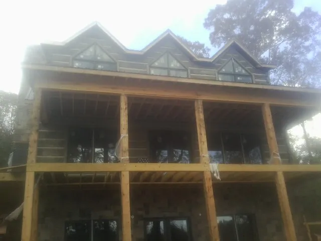 Dormers and porch framing on a large log home under construction in Senecaville