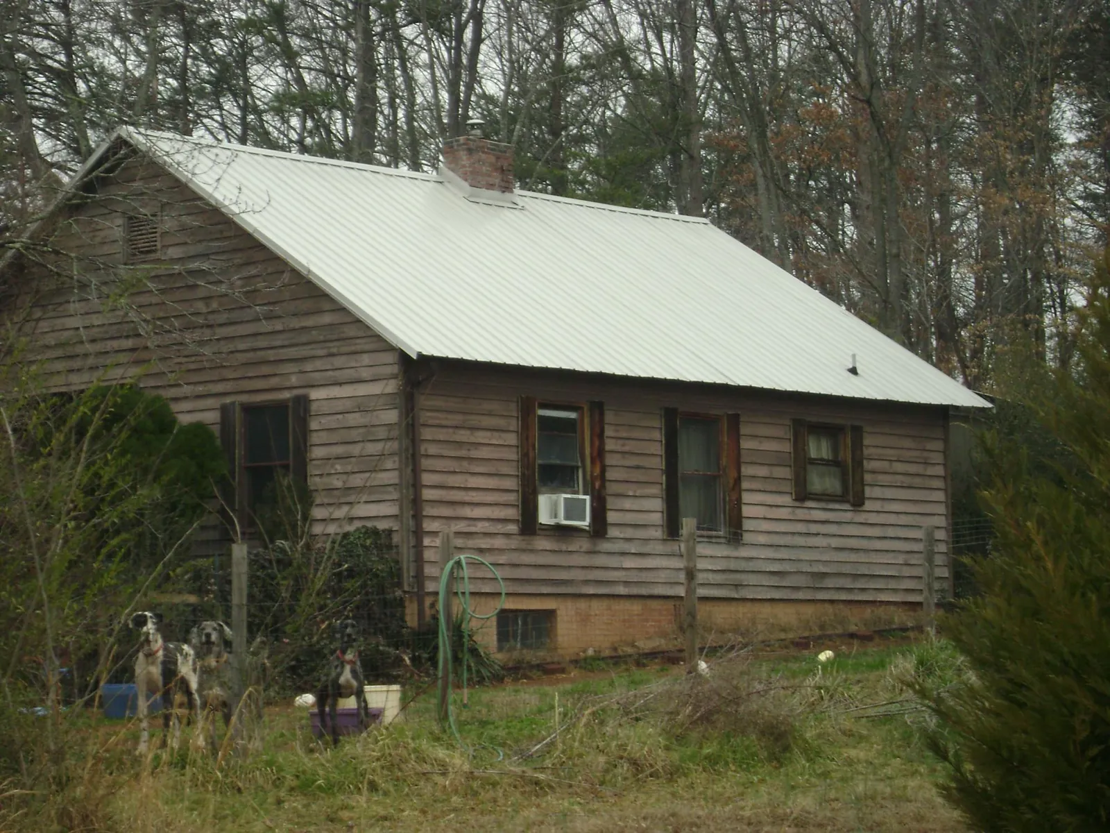 White metal roof on an old wood sided farmhouse, from a Metal Roof Installation job in Senecaville